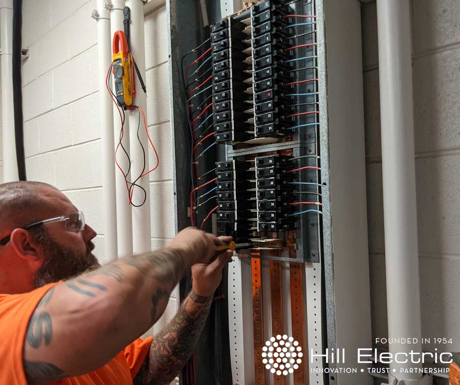 Electrical Panel Wiring being preformed by Hill Electric Employee with Logo